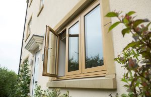 External view of oak effect flush sash window on modern home