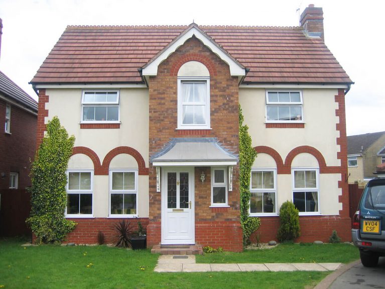 White UPVC entrance door under a canopy.