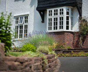 White UPVC windows with Georgian bars on a timber house