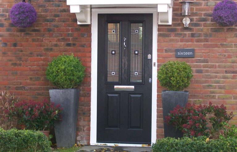 A black composite front door with lead detail