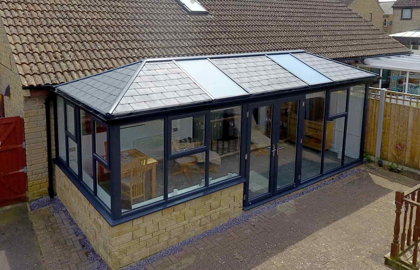 Large conservatory with a grey tiled roof