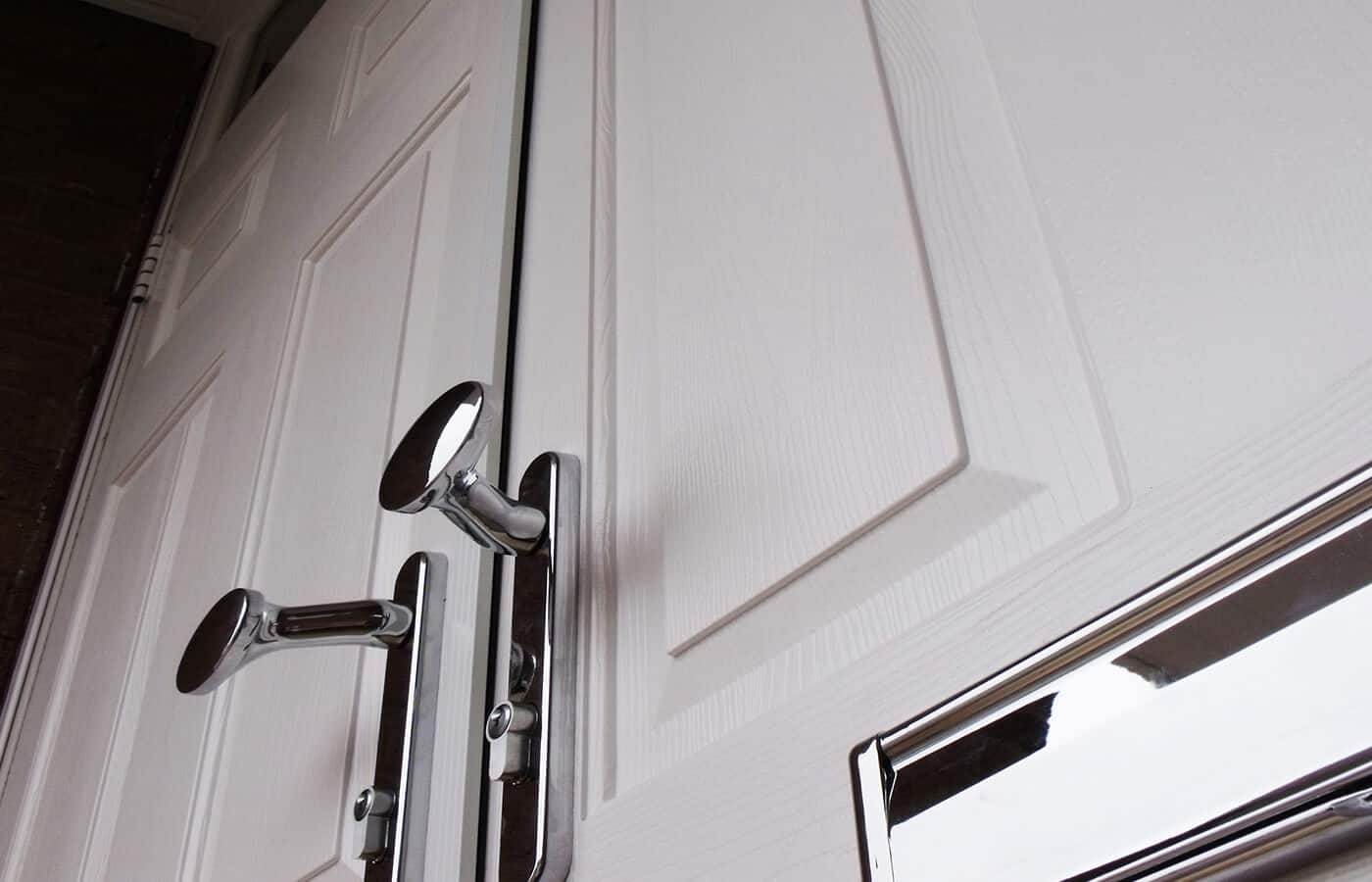 A double entrance door with chrome paddle handles