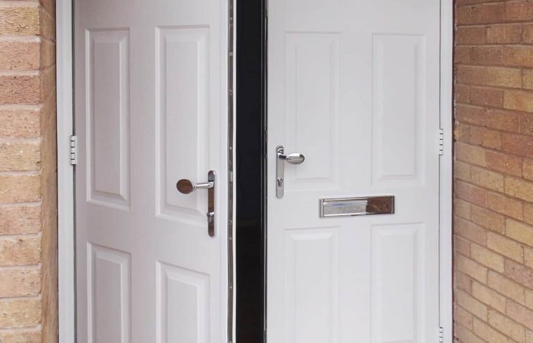 A partially open double entrance door in white