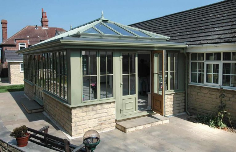 A traditional sage green uPVC orangery