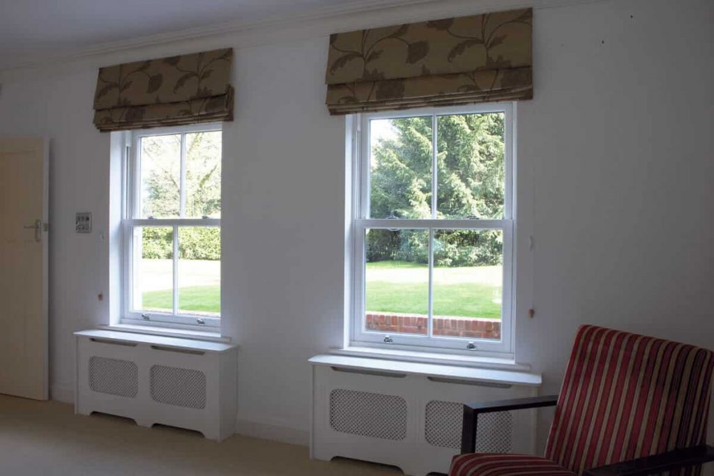 White UPVC vertical slider window with sash pulls.