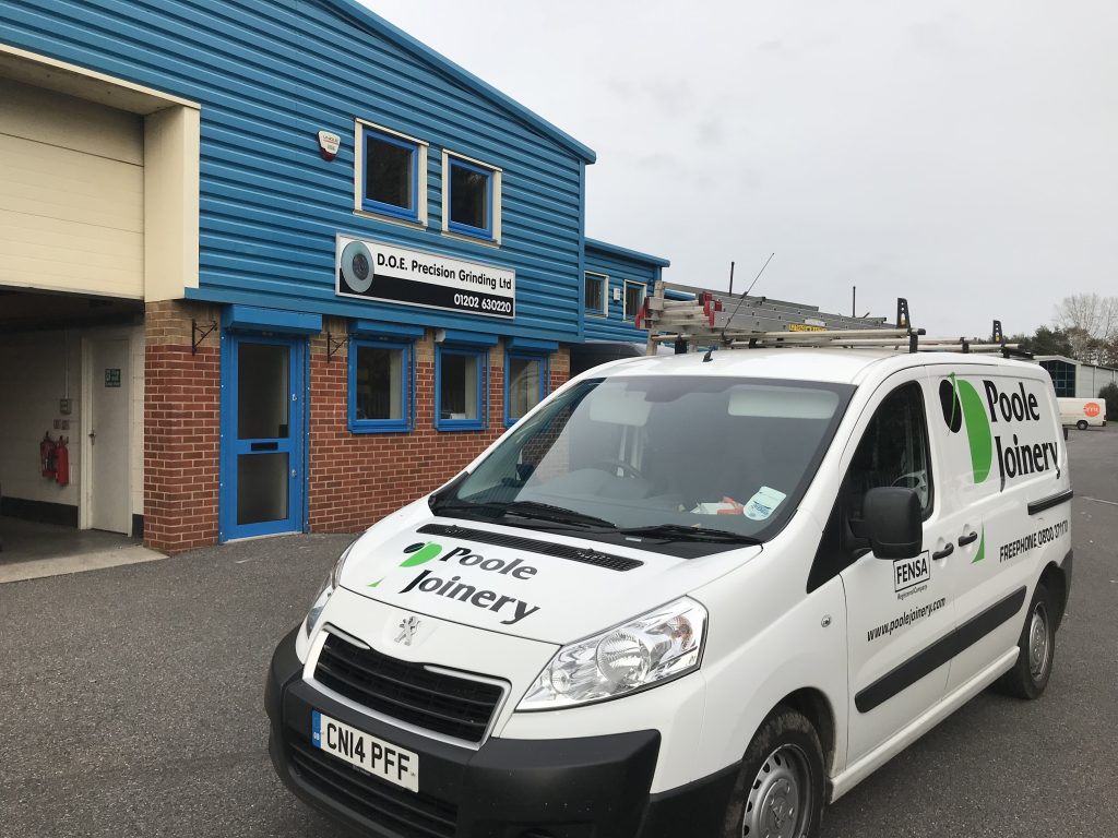 white van parked in front of garage depot